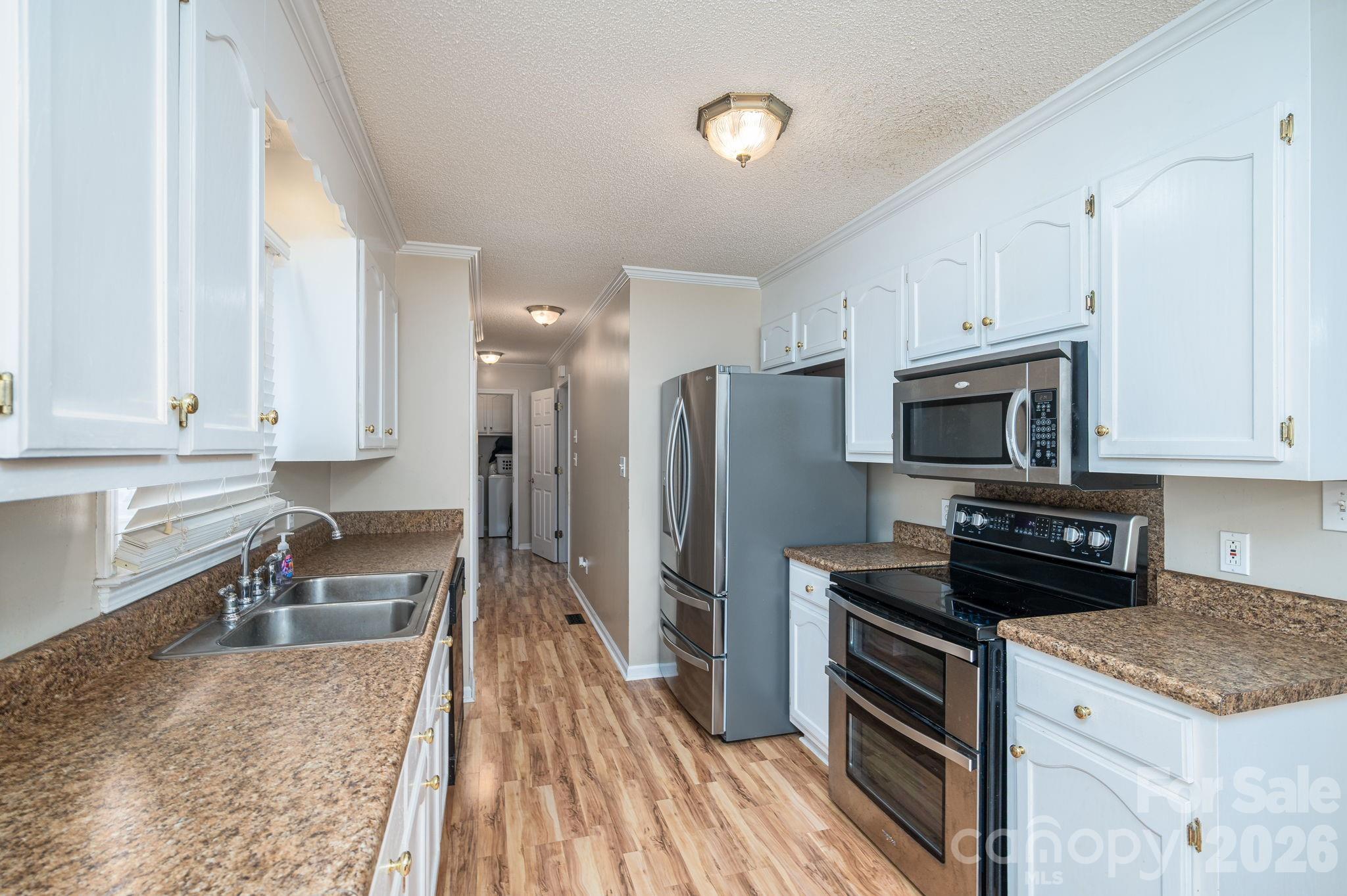 112 Pilots Ridge Drive Bessemer City, NC 28016 - Photo 25 of 36 a kitchen with granite countertop a refrigerator stove and sink