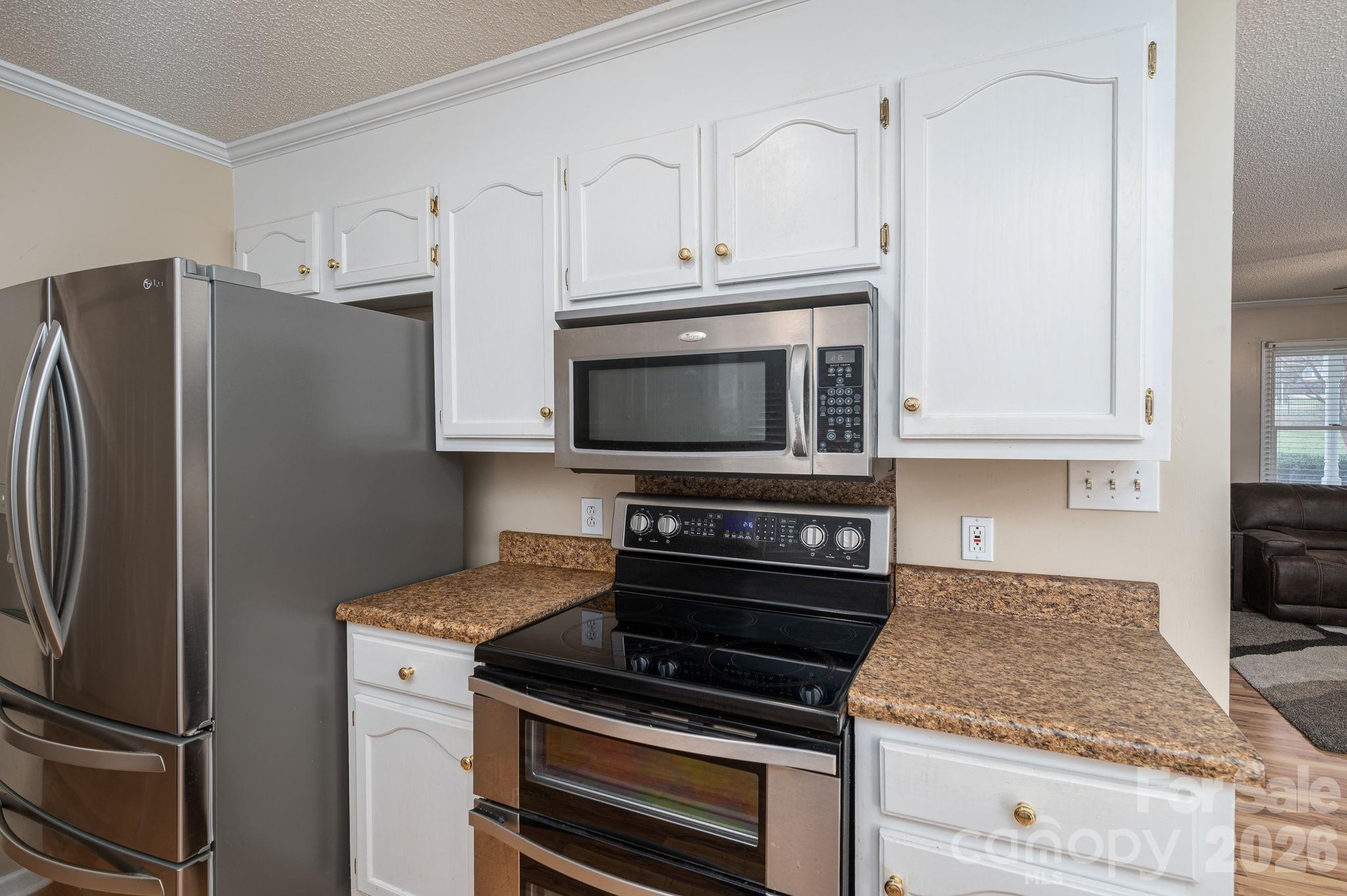 112 Pilots Ridge Drive Bessemer City, NC 28016 - Photo 26 of 36 a kitchen with granite countertop a stove microwave and refrigerator
