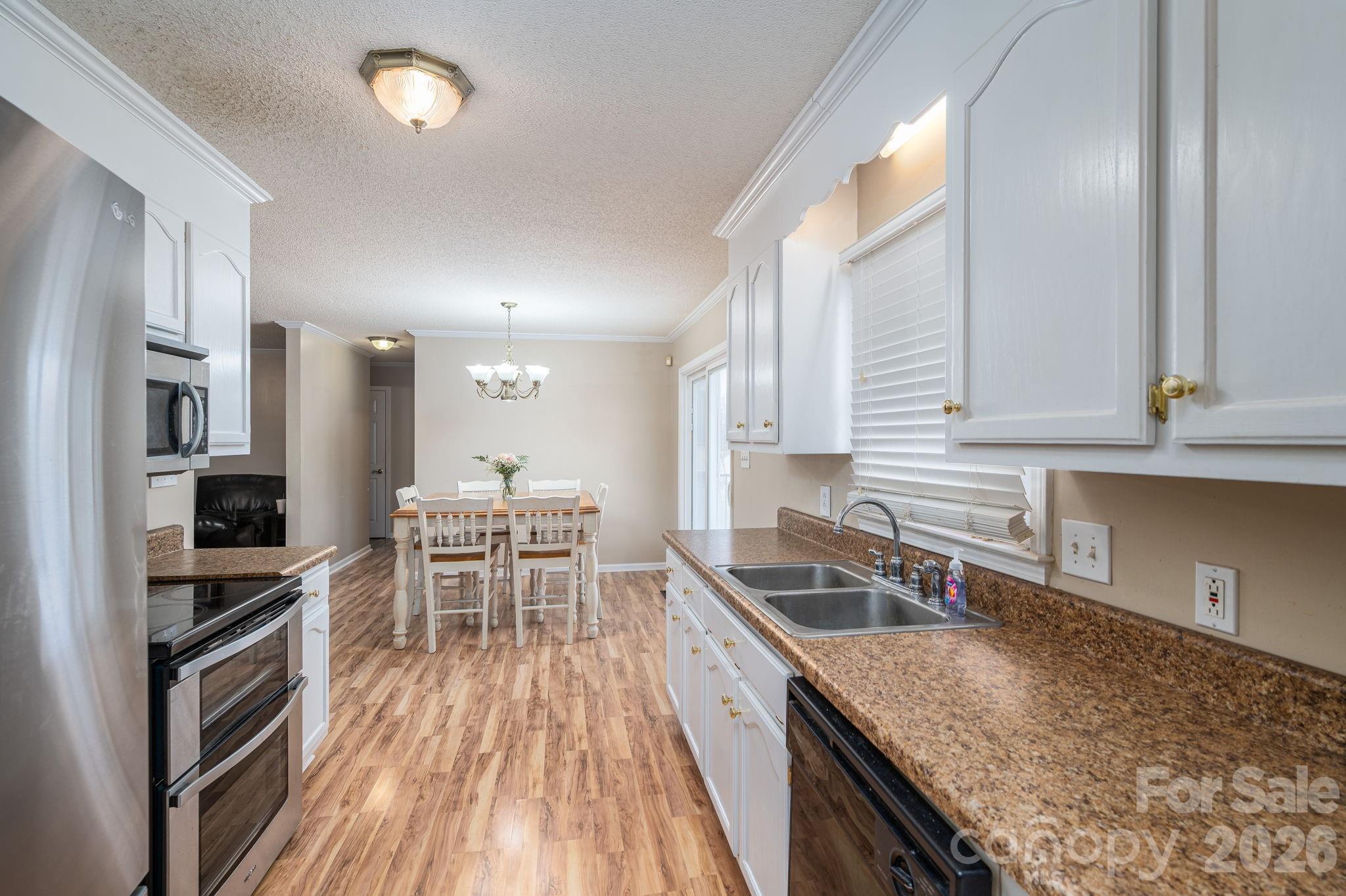 112 Pilots Ridge Drive Bessemer City, NC 28016 - Photo 27 of 36 a kitchen with stainless steel appliances granite countertop sink stove top oven and cabinets