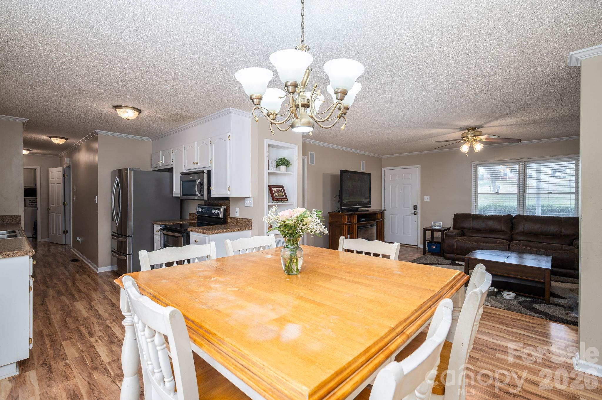 112 Pilots Ridge Drive Bessemer City, NC 28016 - Photo 29 of 36 a room with kitchen island a dining table and wooden floor
