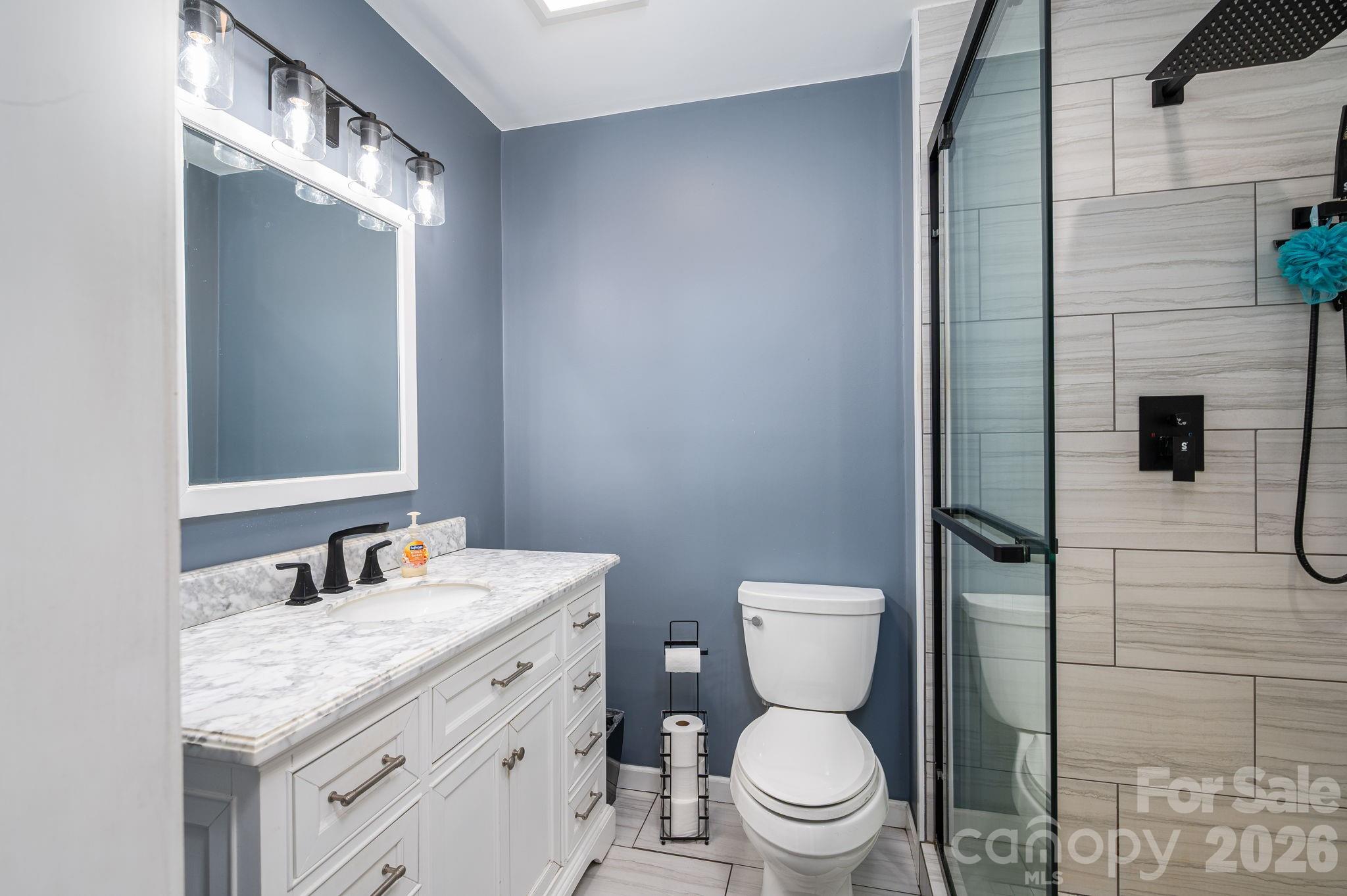 112 Pilots Ridge Drive Bessemer City, NC 28016 - Photo 10 of 36 a bathroom with a granite countertop toilet sink and mirror