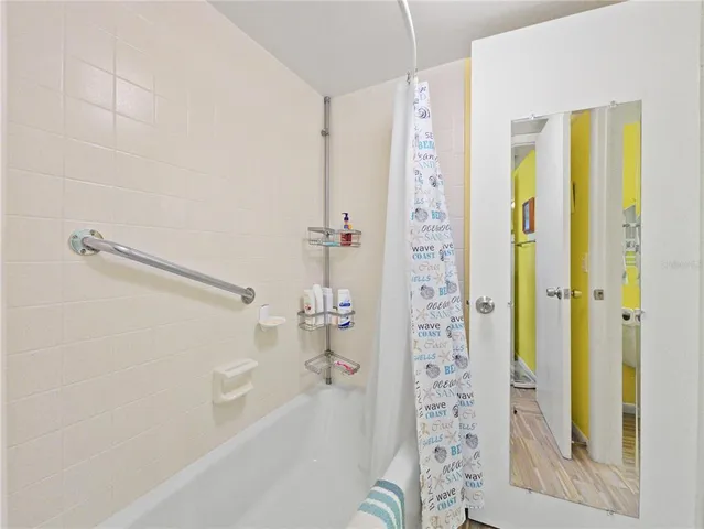 a bathroom with a shower and a tub