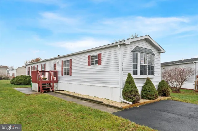 a front view of a house with a garden and plants