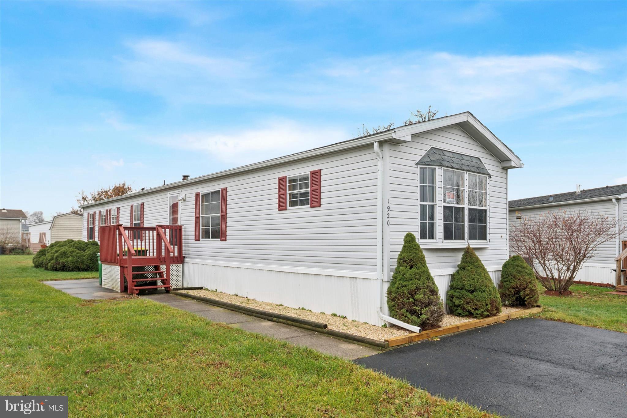 a front view of a house with a garden and plants