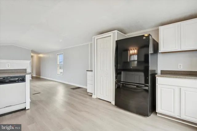 a kitchen with a refrigerator and a stove top oven