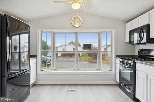 a view of kitchen with stainless steel appliances granite countertop a stove top oven