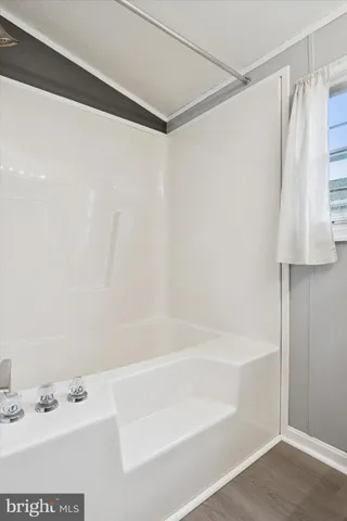 a bathroom with a shower and a bathtub