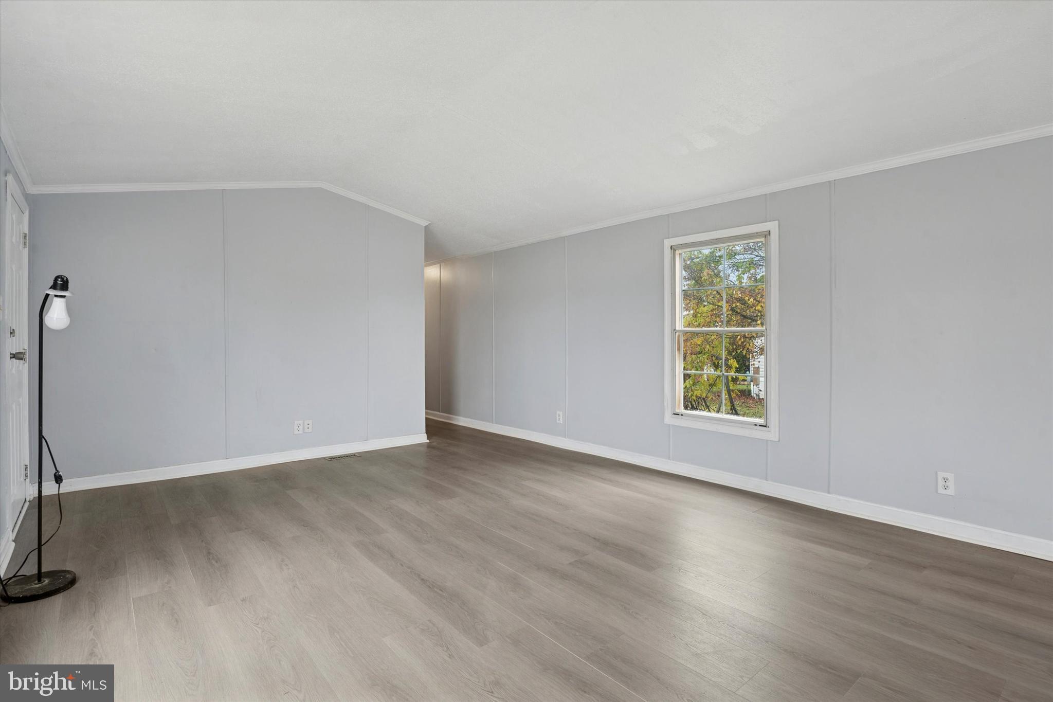 1920 Brian Circle, Unit 650 Bear, DE 19701 - Photo 4 of 25 an empty room with wooden floor and windows