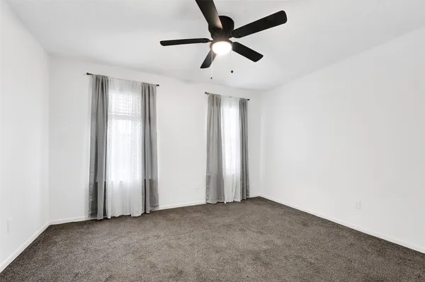 an empty room with closet and wooden floor