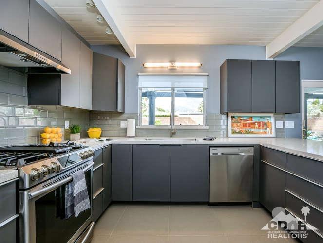 235 North Michelle Road Palm Springs, CA 92262 - Photo 21 of 52 a kitchen with stainless steel appliances a sink stove and cabinets