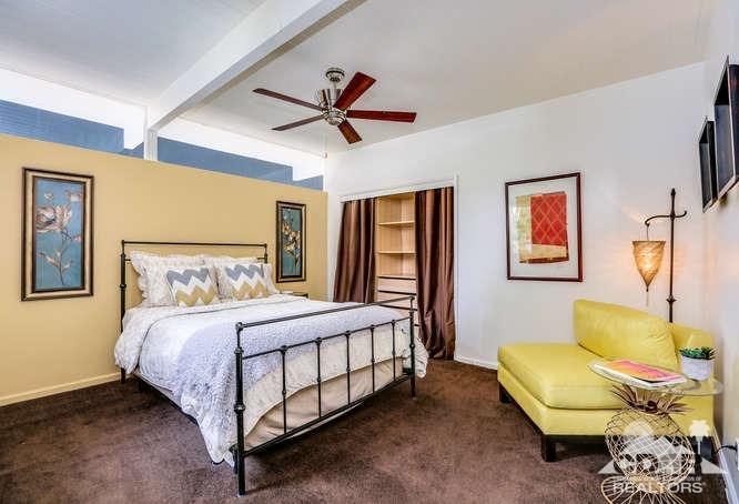235 North Michelle Road Palm Springs, CA 92262 - Photo 27 of 52 a bedroom with a bed and a couch