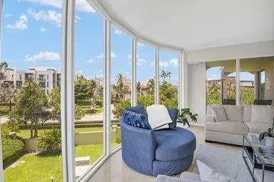 a living room with furniture and a floor to ceiling window