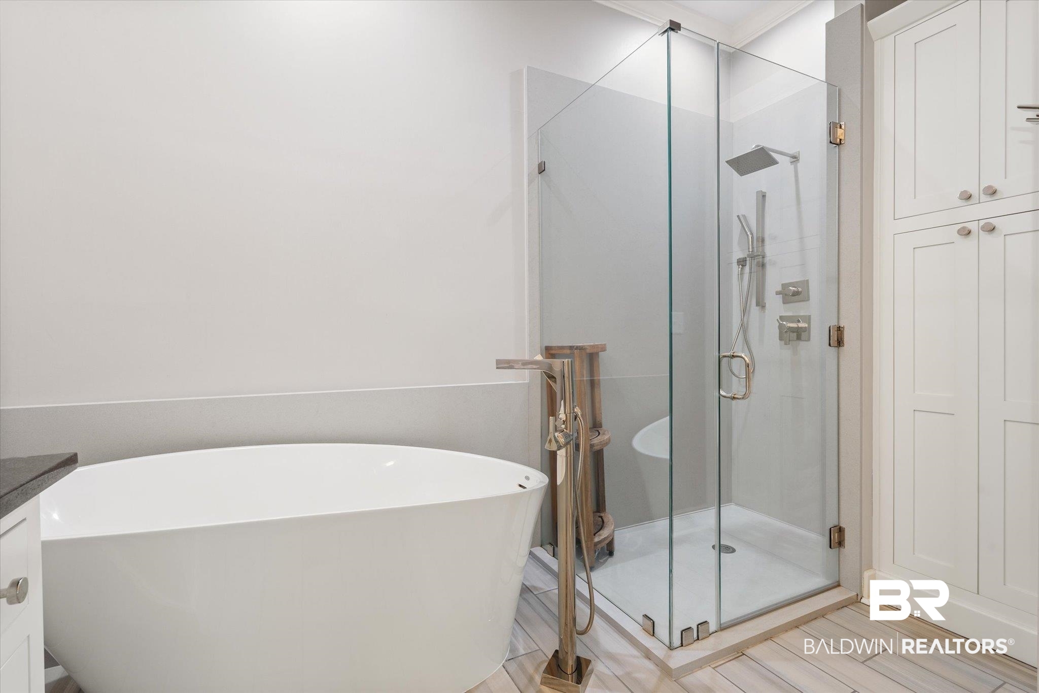 107 Fielding Place Mobile, AL 36608 - Photo 11 of 27 Bathroom with a stall shower, a freestanding tub, wood finished floors, and vanity