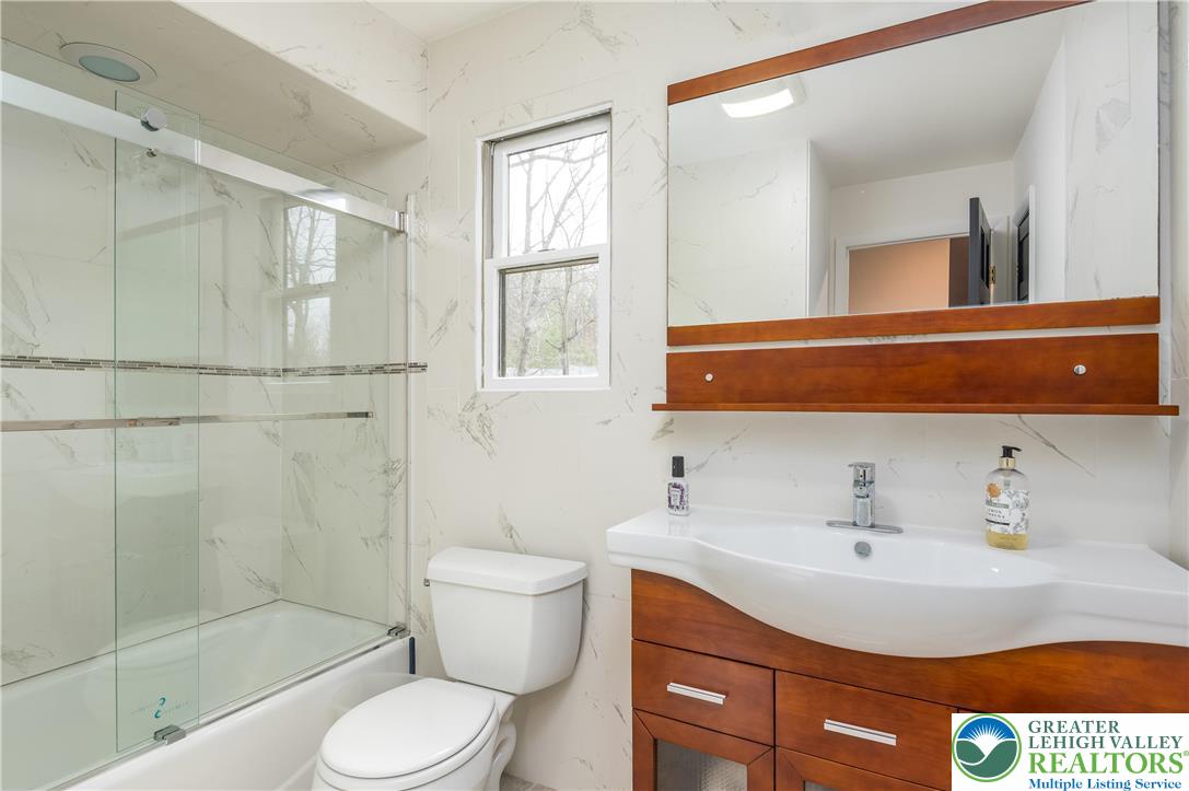 6159 Decker Road Bushkill, PA 18324 - Photo 22 of 49 a bathroom with a sink toilet a mirror and shower