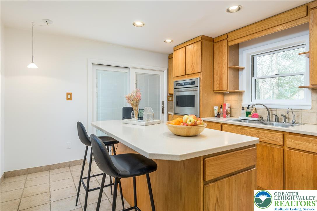 6159 Decker Road Bushkill, PA 18324 - Photo 27 of 49 a kitchen with a sink a stove and chairs