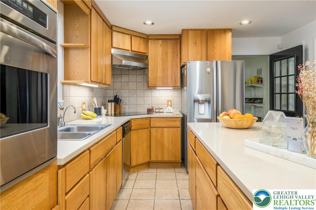6159 Decker Road Bushkill, PA 18324 - Photo 28 of 49 a kitchen with stainless steel appliances granite countertop a sink a refrigerator and a stove