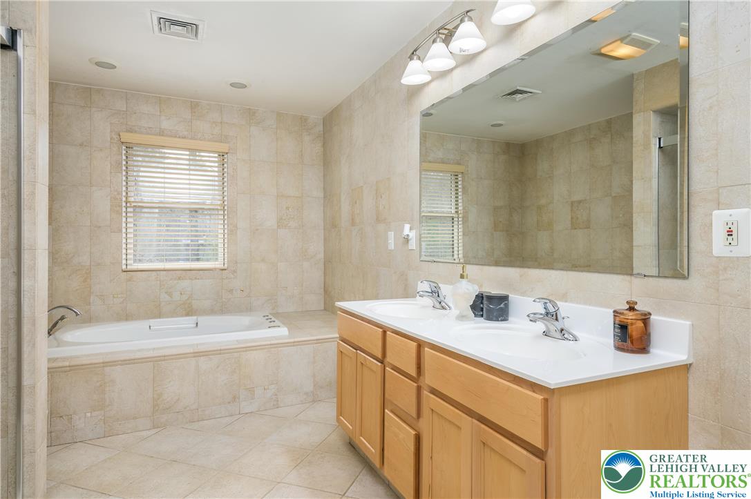 6159 Decker Road Bushkill, PA 18324 - Photo 31 of 49 a bathroom with a sink double vanity granite tub shower and a mirror