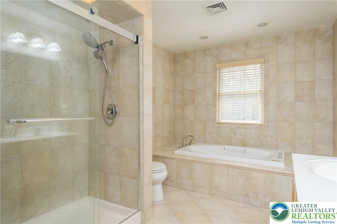 6159 Decker Road Bushkill, PA 18324 - Photo 32 of 49 a bathroom with a bathtub shower and toilet
