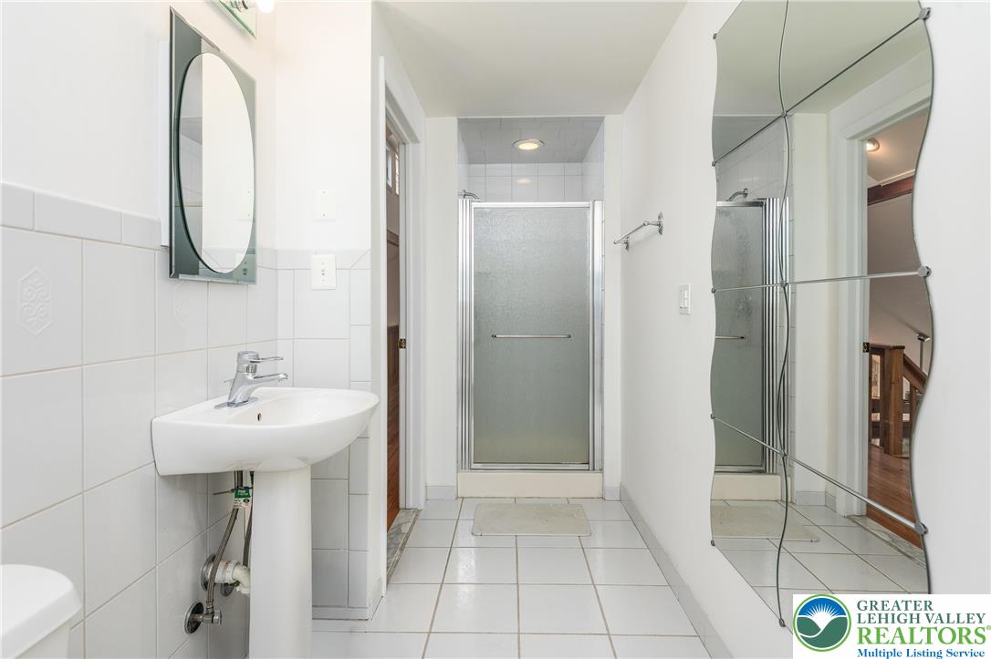 6159 Decker Road Bushkill, PA 18324 - Photo 46 of 49 a bathroom with a sink a mirror and a shower