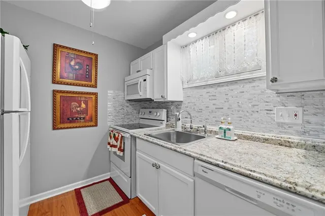 a kitchen with granite countertop a sink and a stove