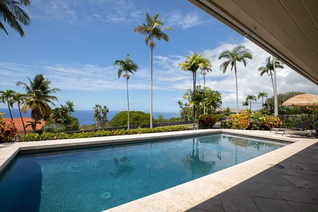 a view of a house with a patio and a garden
