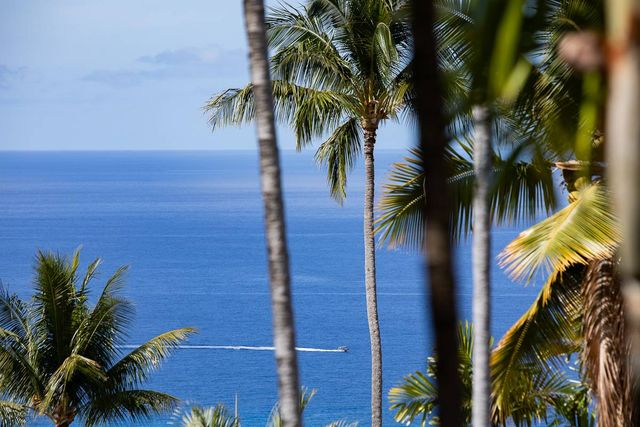 a bedroom with a large bed and a flat tv screen on dresser