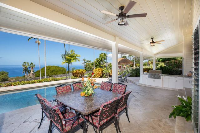 a dining room with furniture and a potted plant