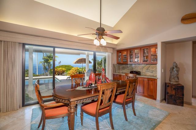 a dining room with furniture a chandelier and window