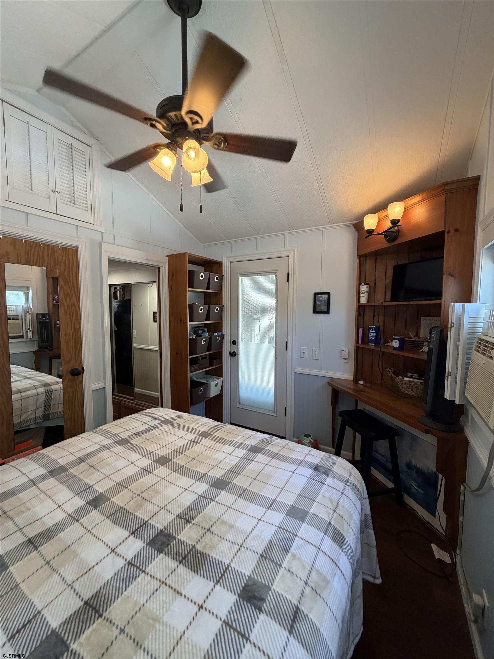 631 Chestnut Neck Road Port Republic, NJ 08241 - Photo 3 of 13 a bedroom with a bed and a chandelier