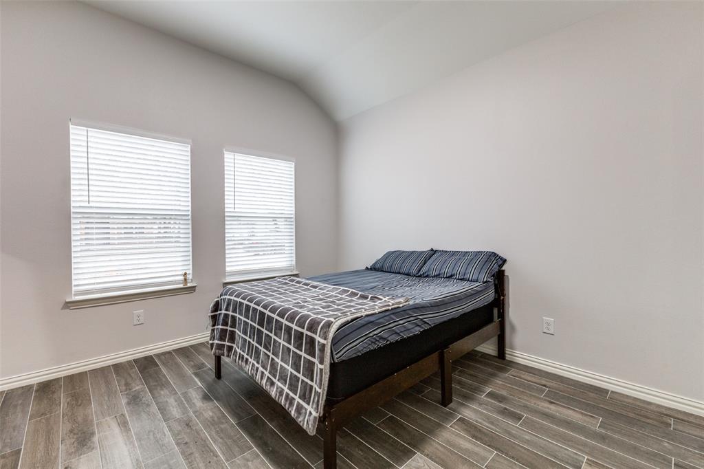 8730 Dunlap Street Dallas, TX 75217 - Photo 13 of 15 a bed sitting in a bedroom next to a window