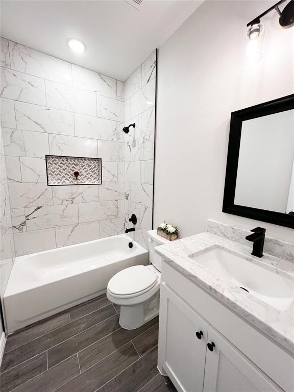 8730 Dunlap Street Dallas, TX 75217 - Photo 15 of 15 a bathroom with a granite countertop toilet sink and mirror