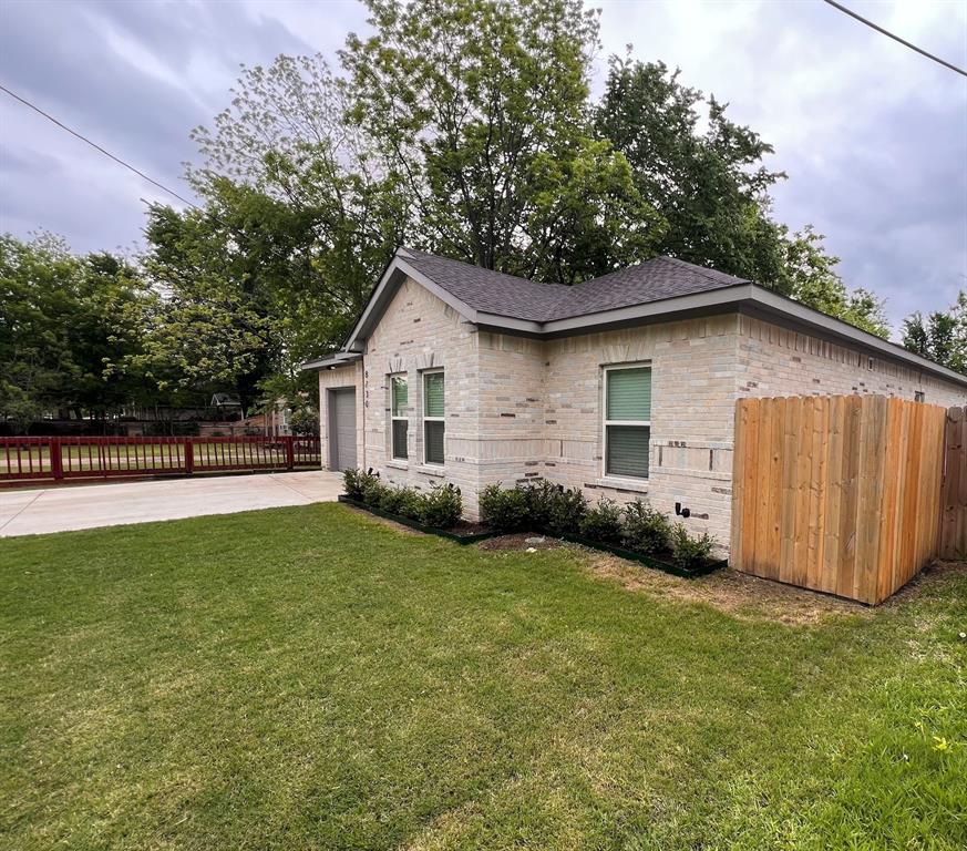 8730 Dunlap Street Dallas, TX 75217 - Photo 2 of 15 a view of a backyard with a garden