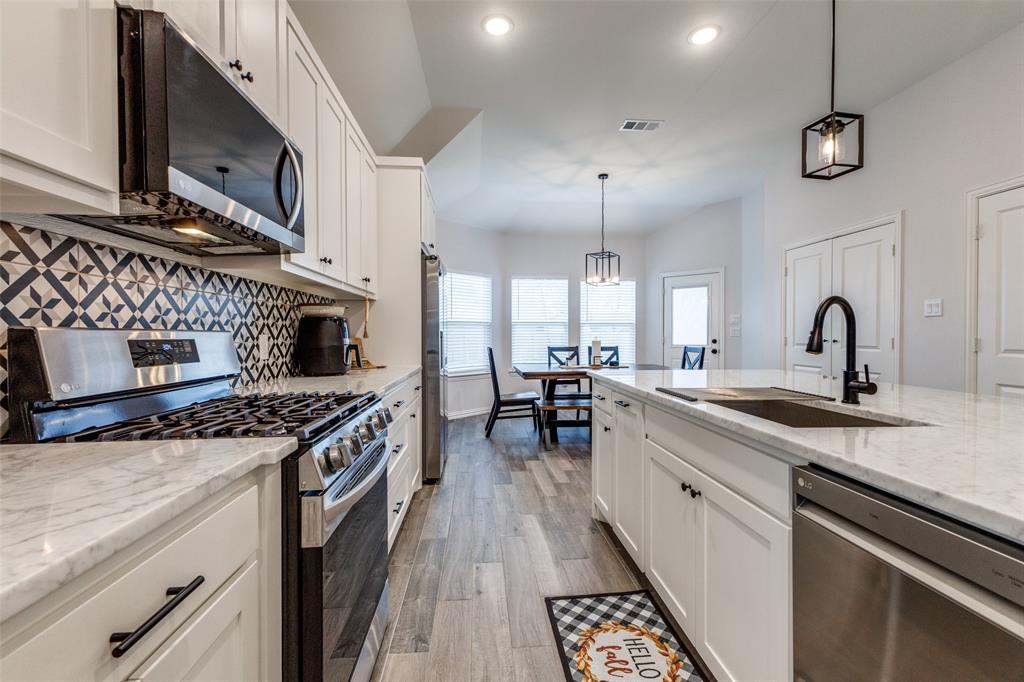 8730 Dunlap Street Dallas, TX 75217 - Photo 4 of 15 a kitchen with a stove and a sink