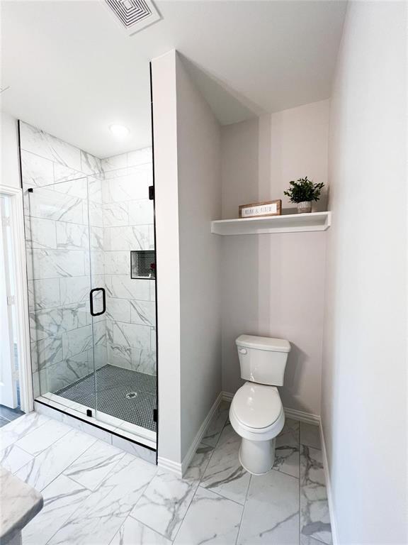 8730 Dunlap Street Dallas, TX 75217 - Photo 9 of 15 a bathroom with a toilet and a shower