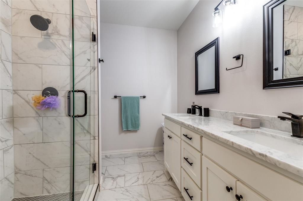 8730 Dunlap Street Dallas, TX 75217 - Photo 10 of 15 a spacious bathroom with a granite countertop shower sink and mirror