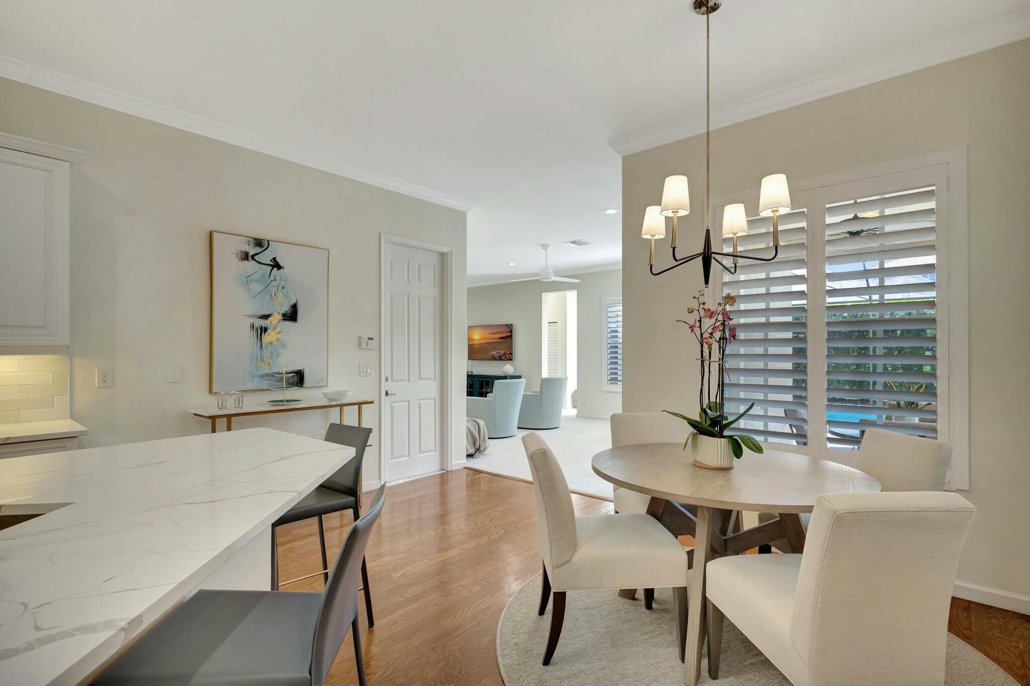 106 Via Santa Cruz Jupiter, FL 33458 - Photo 25 of 71 a view of a dining room with furniture and wooden floor