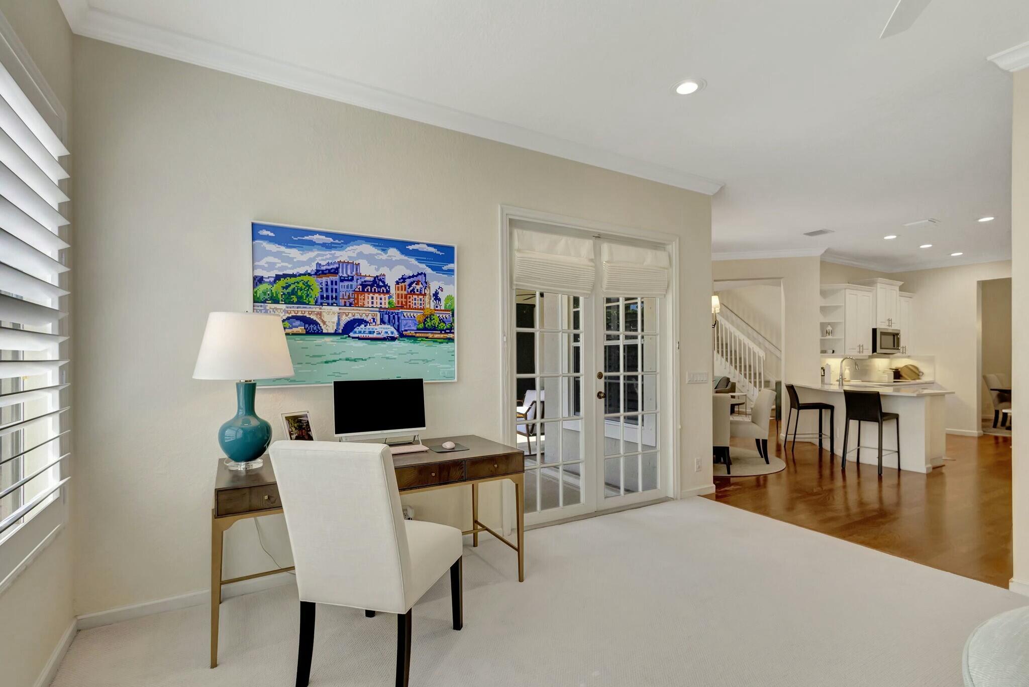 106 Via Santa Cruz Jupiter, FL 33458 - Photo 28 of 71 a workspace with furniture and a flat screen tv