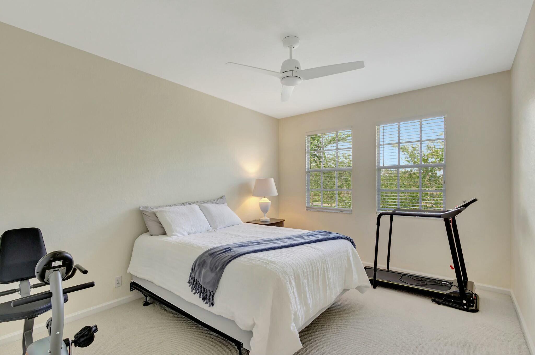 106 Via Santa Cruz Jupiter, FL 33458 - Photo 32 of 71 a bedroom with a bed and a window