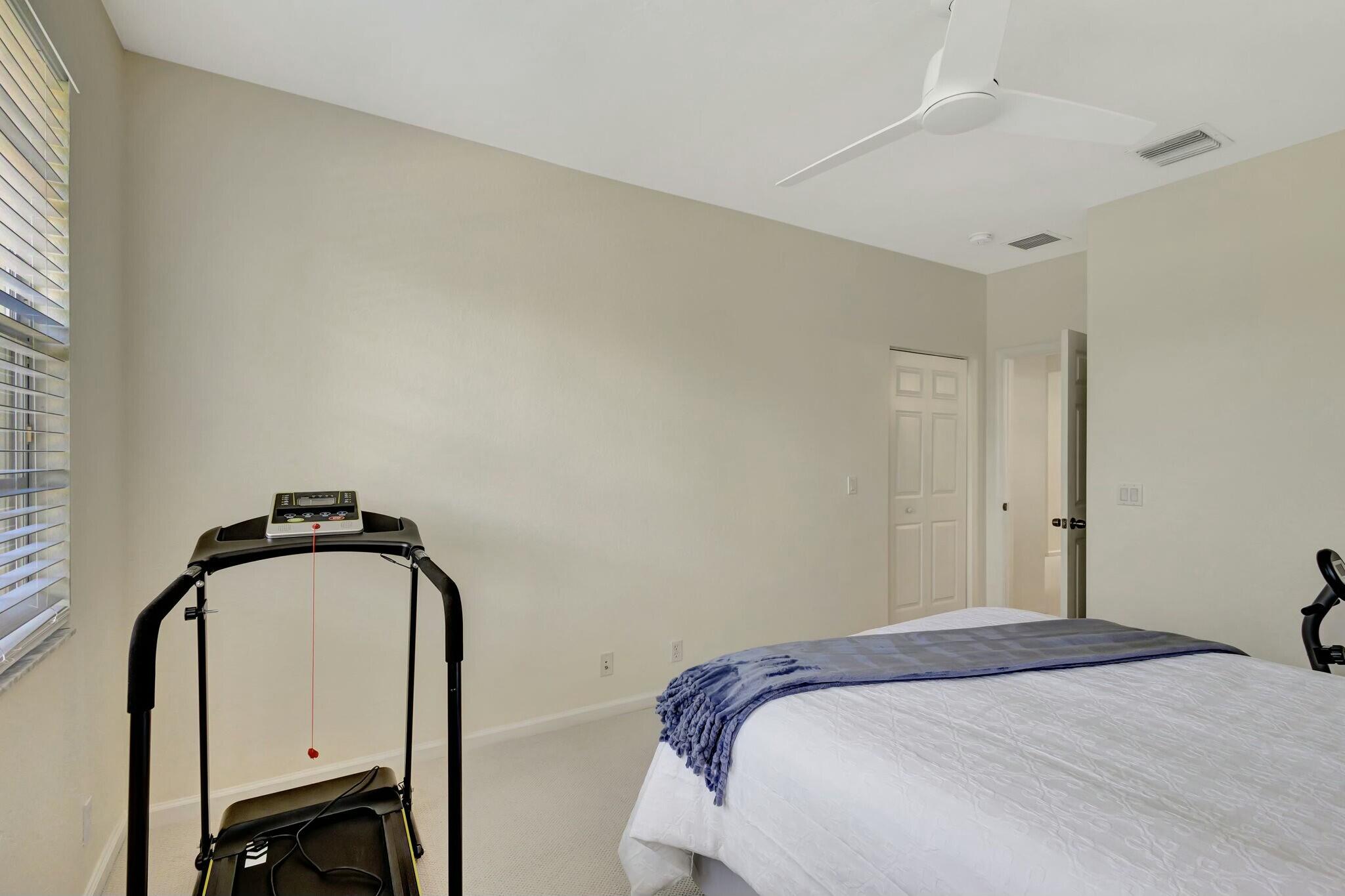 106 Via Santa Cruz Jupiter, FL 33458 - Photo 33 of 71 a bedroom with a bed and a dresser