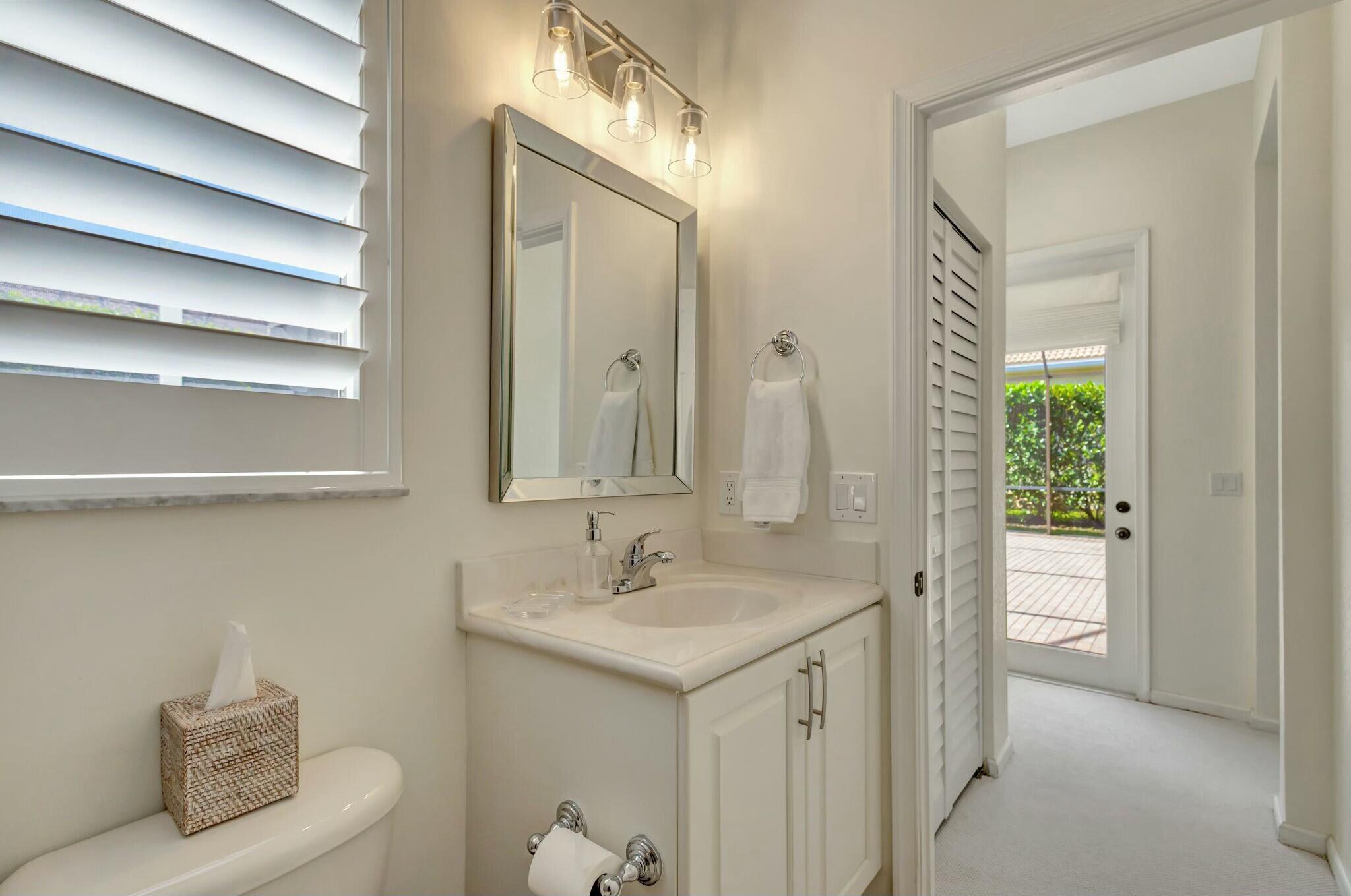 106 Via Santa Cruz Jupiter, FL 33458 - Photo 35 of 71 a bathroom with a sink and a mirror