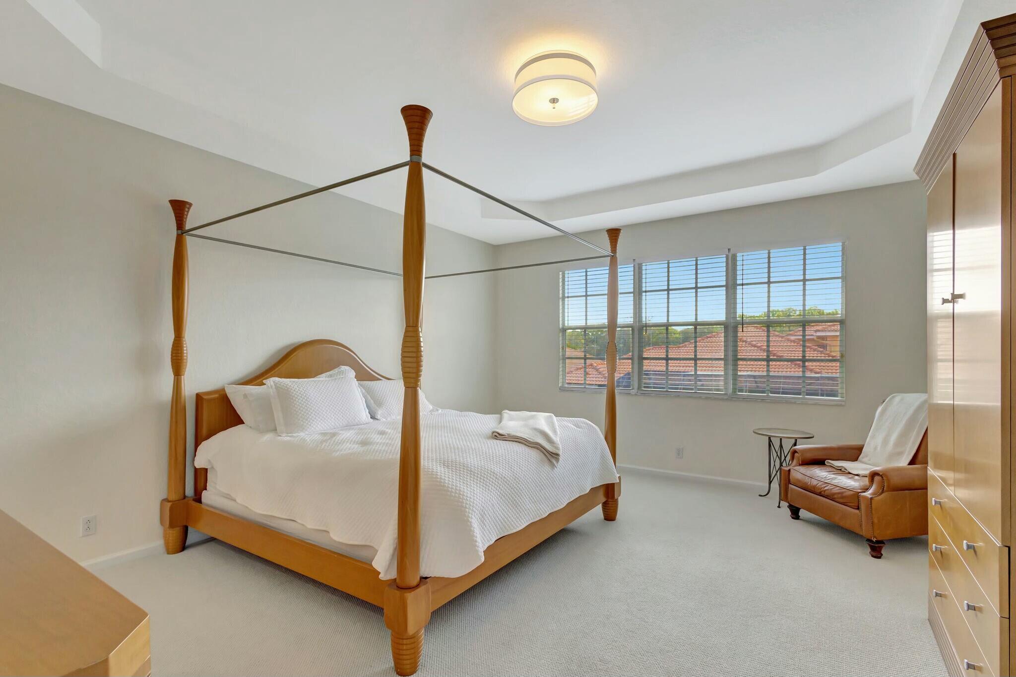 106 Via Santa Cruz Jupiter, FL 33458 - Photo 40 of 71 a bed room with a bed and a chair