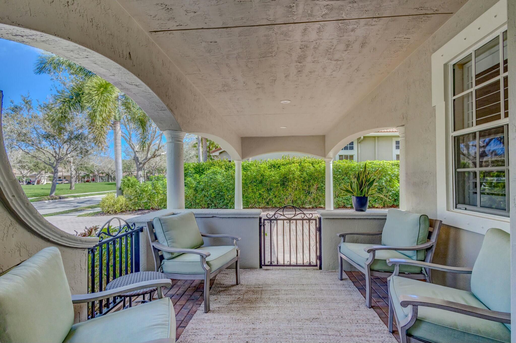 106 Via Santa Cruz Jupiter, FL 33458 - Photo 52 of 71 a view of a patio with couches chairs and wooden floor