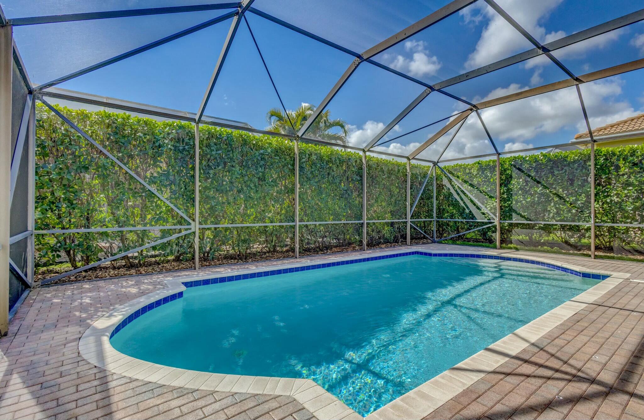 106 Via Santa Cruz Jupiter, FL 33458 - Photo 55 of 71 a view of a backyard with a swimming pool