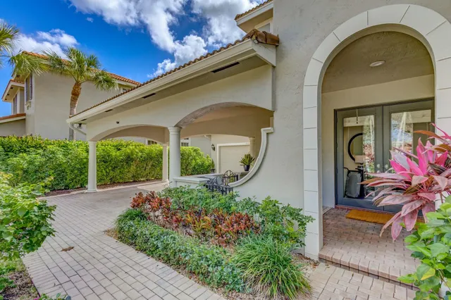 a kitchen with a table chairs refrigerator and cabinets