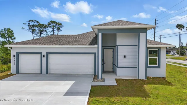 a front view of a house with a garden
