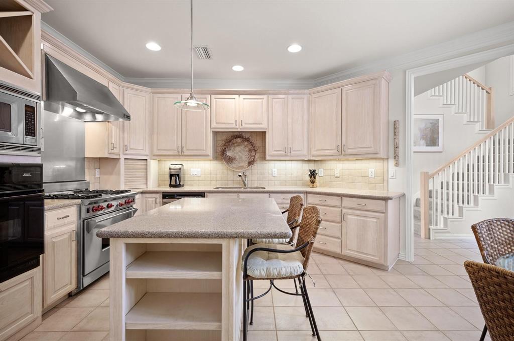 4209 Sexton Lane Dallas, TX 75229 - Photo 12 of 27 a kitchen with a stove a sink and a refrigerator