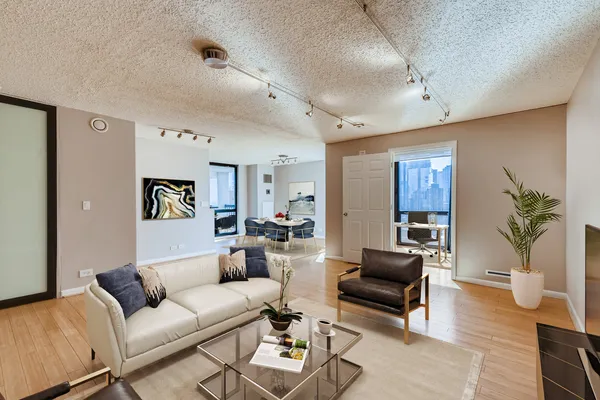 a living room with furniture and wooden floor