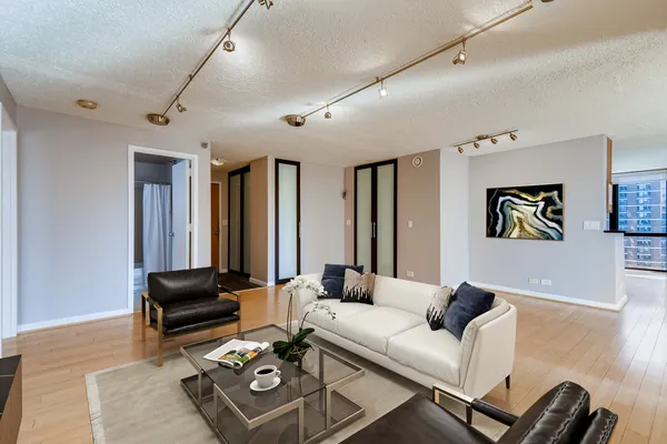 a living room with furniture a couch and a window