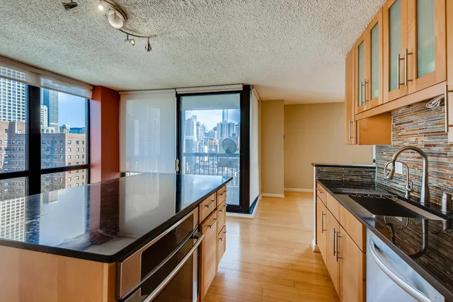 a kitchen with stainless steel appliances granite countertop a stove a sink and a refrigerator