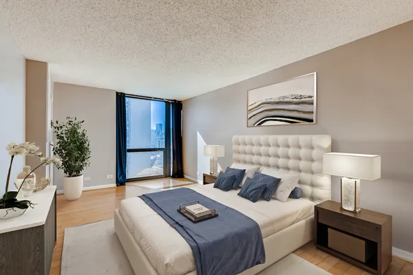 a bedroom with a bed and a potted plant